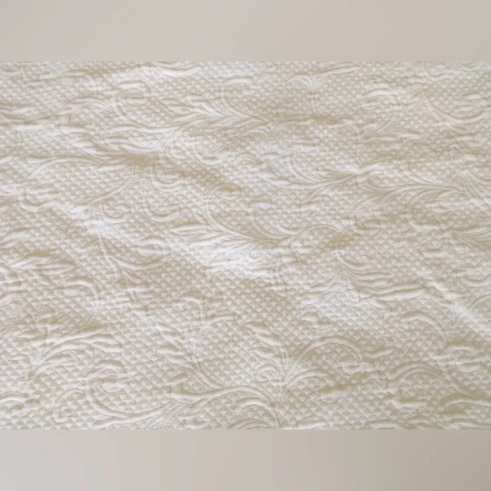 white matelassé coverlet